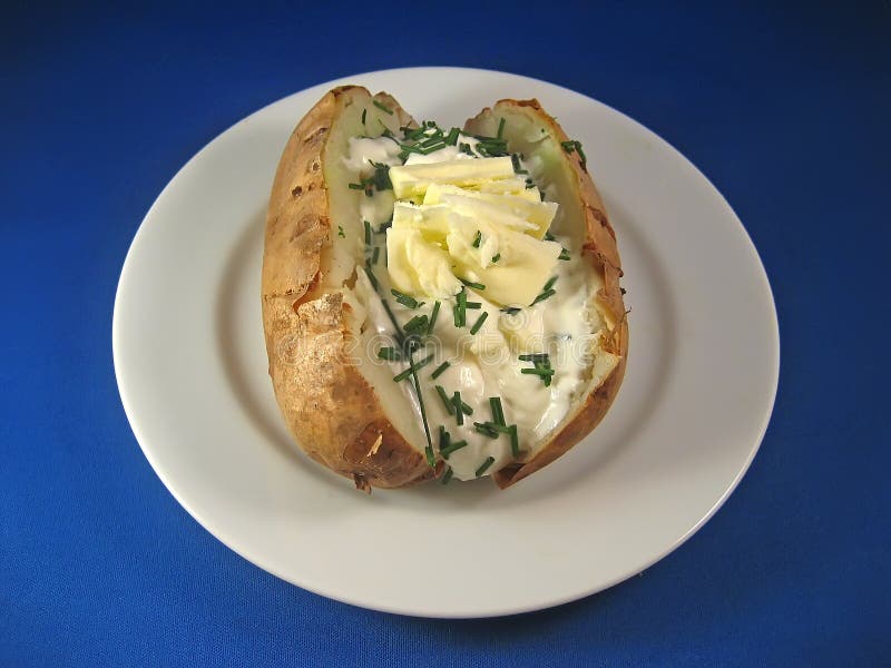 Baked potato with sour cream and chives. Baked potato with sour cream and chives.