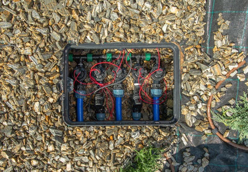 Close Up Of Hydraulic Automated Solenoid Valves In Home Garden Underground Irrigation Sprinkler System. Close Up Of Hydraulic Automated Solenoid Valves In Home Garden Underground Irrigation Sprinkler System