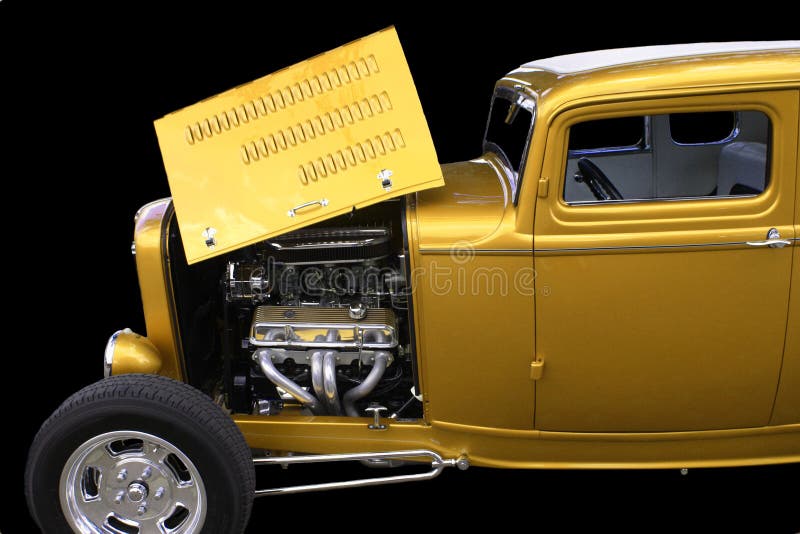 Restored American gold automobile with hood compartment open and engine exposed. Restored American gold automobile with hood compartment open and engine exposed.