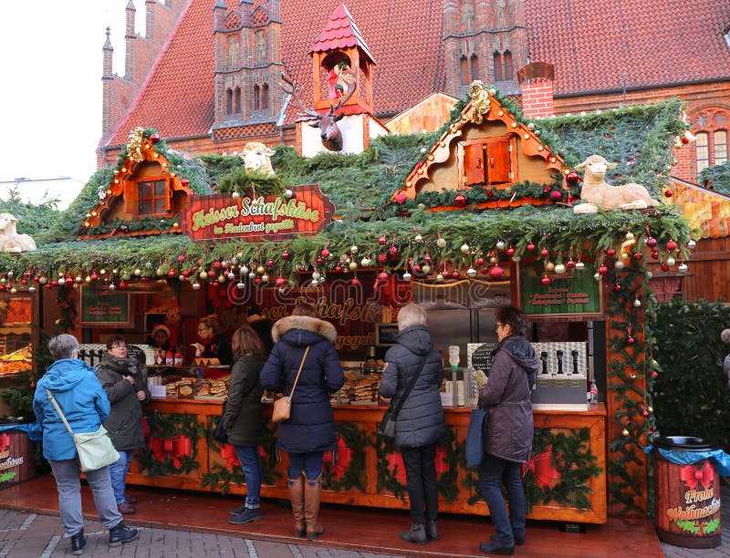 HANNOVER,GERMANY-DECEMBER 1: Customers buying Warm Cheese Sandwich at Christmas Market Weihnachtsmarkt. December 1,2018 in Hannover,Germany. HANNOVER,GERMANY-DECEMBER 1: Customers buying Warm Cheese Sandwich at Christmas Market Weihnachtsmarkt. December 1,2018 in Hannover,Germany.