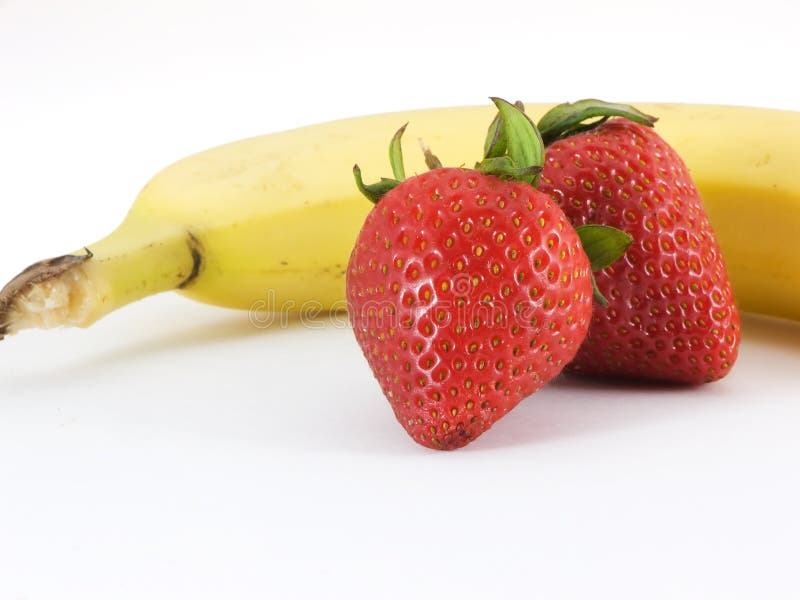 Banana and strawberries on a white background. Banana and strawberries on a white background