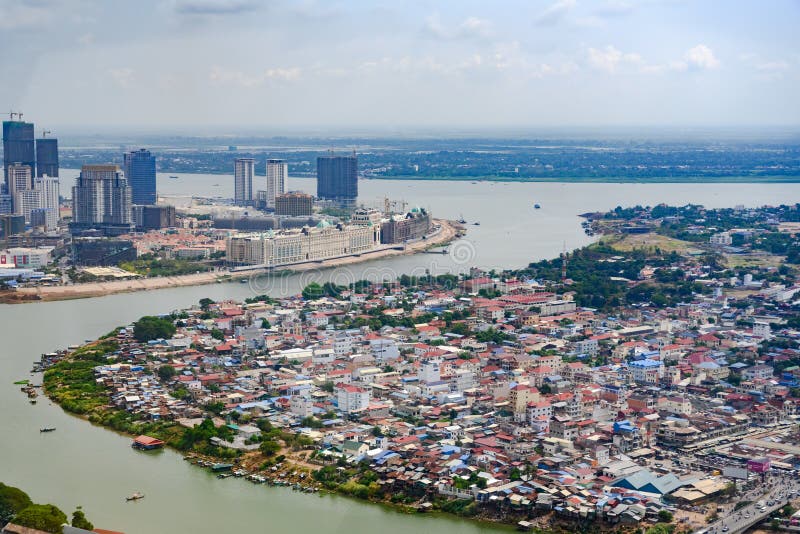 Koh Pich is an island in the Bassac River, just before it empties into the Mekong River. The Elysee project, which is a homage to Paris with a grand boulevard and haussmann-esque rows of apartment blocks. China is being the largest visitor country to Cambodia. In the foreground you see an aerial view of Bassac River, waste, shacks and Marche Chbar Ampov in Phnom Penh, Cambodia. Koh Pich is an island in the Bassac River, just before it empties into the Mekong River. The Elysee project, which is a homage to Paris with a grand boulevard and haussmann-esque rows of apartment blocks. China is being the largest visitor country to Cambodia. In the foreground you see an aerial view of Bassac River, waste, shacks and Marche Chbar Ampov in Phnom Penh, Cambodia