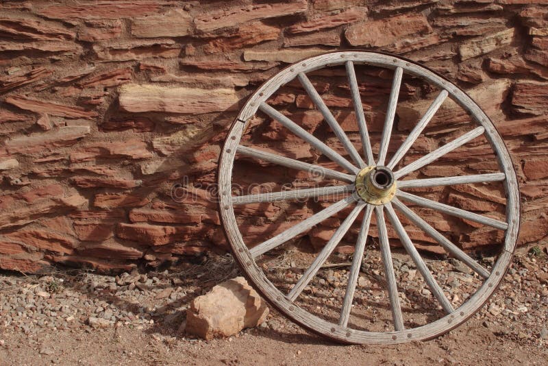 Wagon wheel and stone wall of the Hopi House - Grand Canyon National Park. Wagon wheel and stone wall of the Hopi House - Grand Canyon National Park