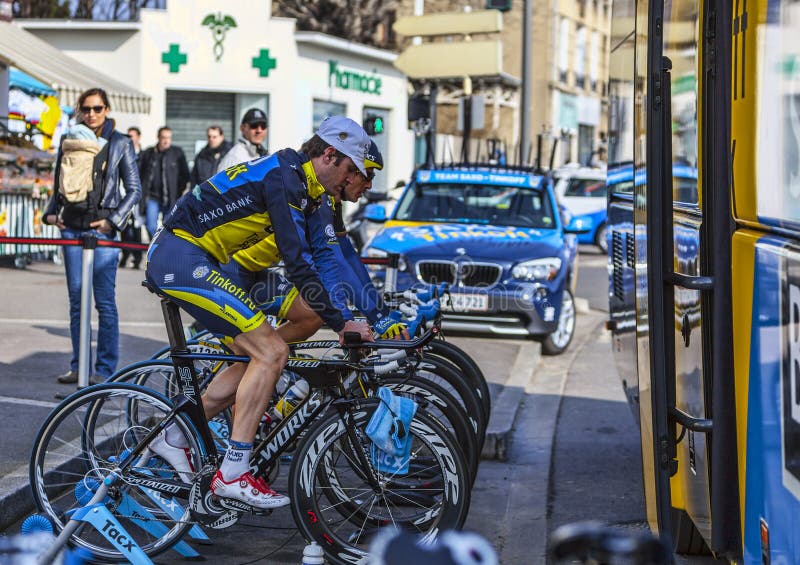 Houilles,France- March 3rd, 2013: Cyclists from the Danish Team Saxo-Thinkoff warming -up at the training stand near the team's trucks before the start in the Prologue stage of the race Paris Nice 2013. Houilles,France- March 3rd, 2013: Cyclists from the Danish Team Saxo-Thinkoff warming -up at the training stand near the team's trucks before the start in the Prologue stage of the race Paris Nice 2013.