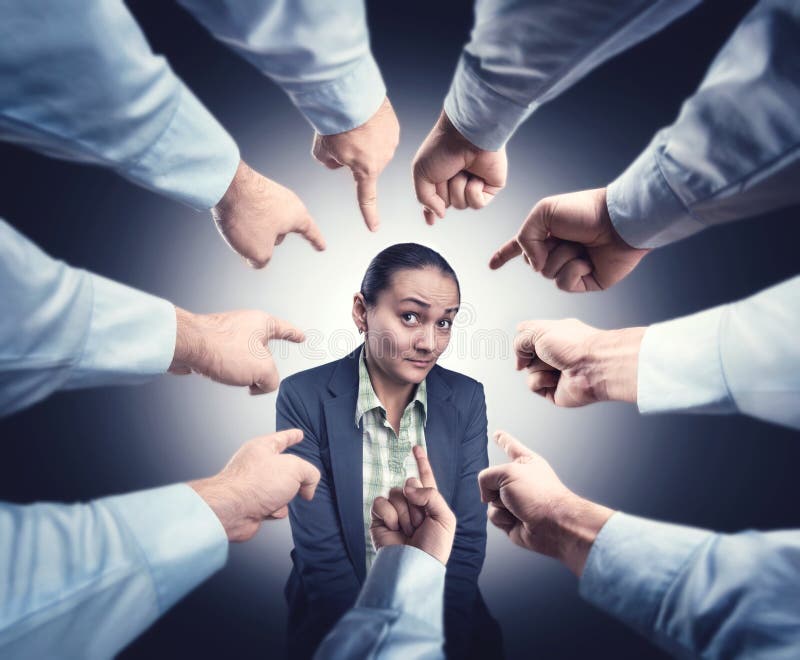 Shy businesswoman with men's fingrers pointed at her. Shy businesswoman with men's fingrers pointed at her