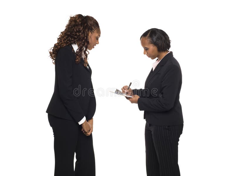 Stock photo of an African American businesswoman answering a questionaire being taken by another businesswoman. Stock photo of an African American businesswoman answering a questionaire being taken by another businesswoman.