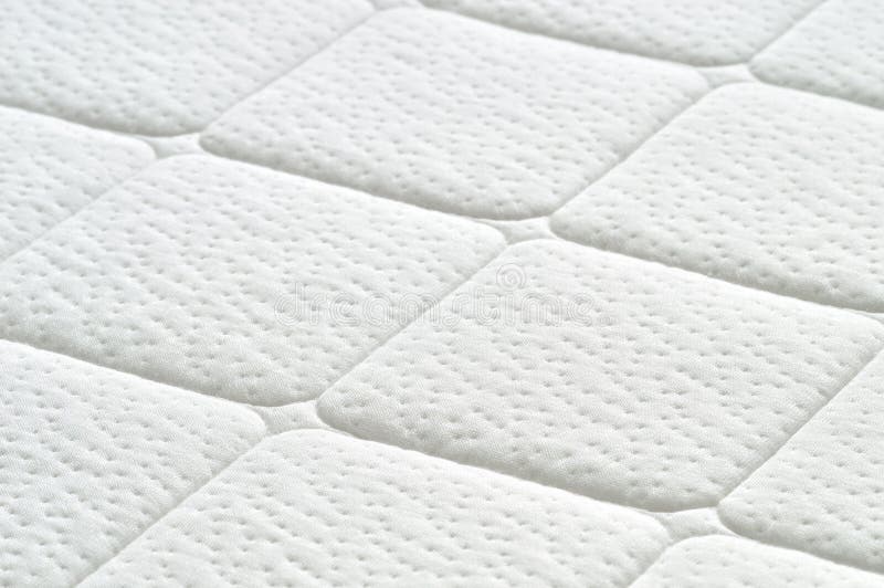 Close-up of white mattress texture. Patter of quilted material. Comfortable mattress. Copy space. Close-up of white mattress texture. Patter of quilted material. Comfortable mattress. Copy space.