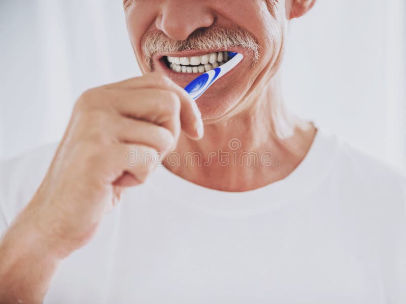 Close up. Senior Man Brushing Teeth in Bathroom. Morning Routine. Healthcare Roncepts. Elder Person at Home. Smiling Man. White Teeth. Smiling Grandfather. Dental Hygiene Concepts. Close up. Senior Man Brushing Teeth in Bathroom. Morning Routine. Healthcare Roncepts. Elder Person at Home. Smiling Man. White Teeth. Smiling Grandfather. Dental Hygiene Concepts.