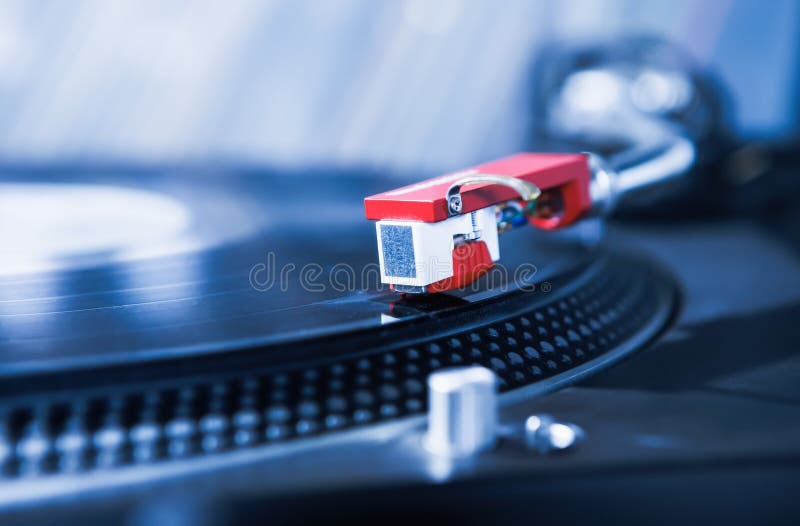 Turntable vinyl record player for DJ. Turntables needle in focus playing records with music.Analog studio equipment for hifi audio enthusiast,professional party disc jockey. Turntable vinyl record player for DJ. Turntables needle in focus playing records with music.Analog studio equipment for hifi audio enthusiast,professional party disc jockey