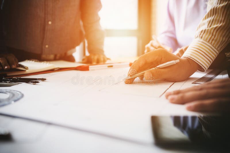 Consultation between colleagues, engineering team to check the blueprint used to build commercial buildings for joint ventures. Consultation between colleagues, engineering team to check the blueprint used to build commercial buildings for joint ventures.