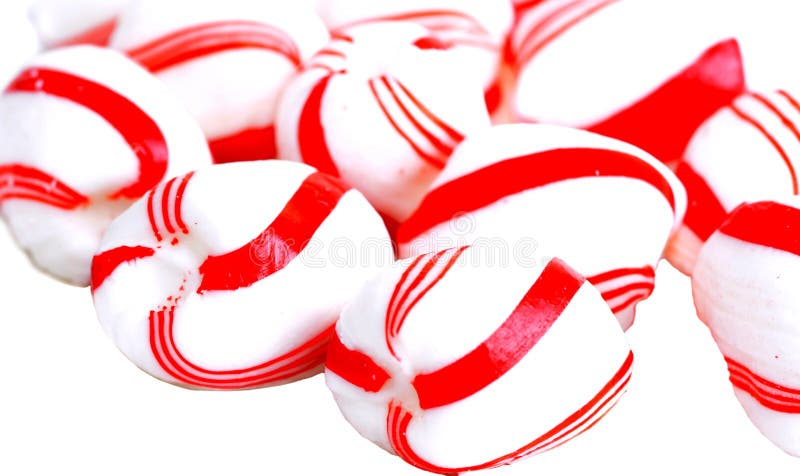 Macro shot of peppermint candy over a white plate. Macro shot of peppermint candy over a white plate