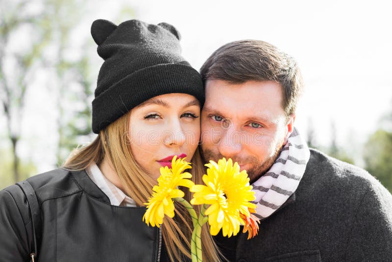 Концепция влюбленности, отношения, семьи и людей - пары с букетом gerberas в осени паркуют стоковое изображение Концепция влюбленности, отношения, семьи и людей - пары с букетом gerberas в осени паркуют стоковое изображение
