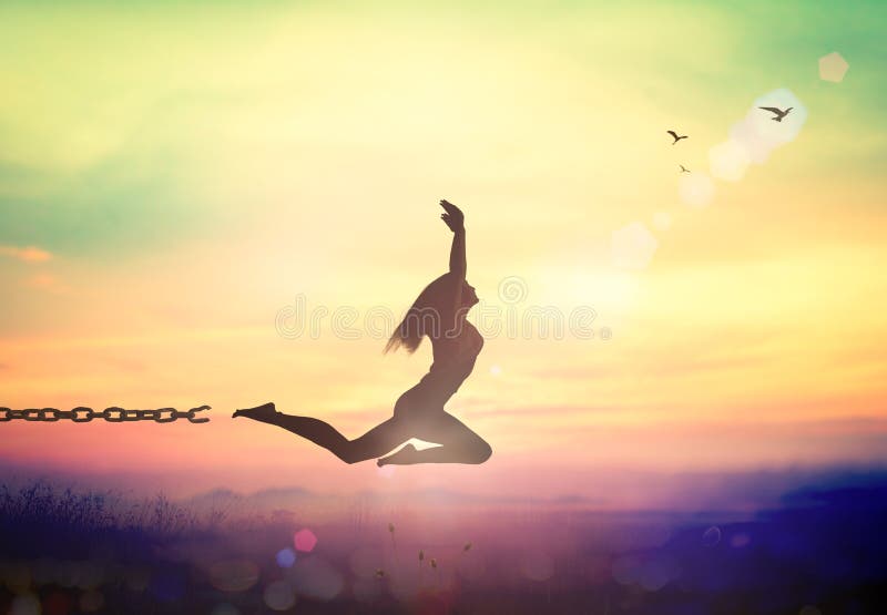 Silhouette of a girl jumping and broken chains at sunset mountain with her hands raised. Silhouette of a girl jumping and broken chains at sunset mountain with her hands raised