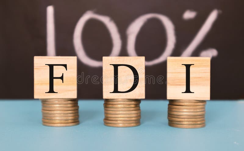 Finance Concept with Stack of Coins - 100 percent FDI or Foreign Direct Investment on wooden blocks. Finance Concept with Stack of Coins - 100 percent FDI or Foreign Direct Investment on wooden blocks