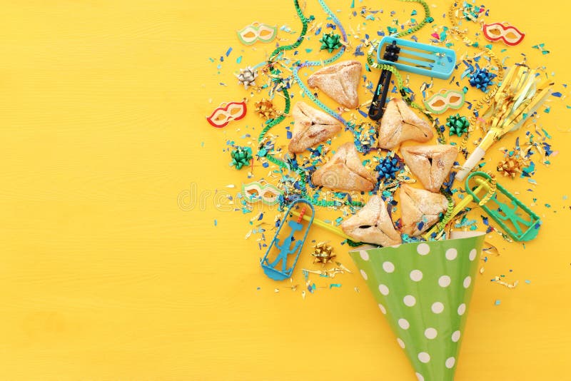 Концепция торжества Purim & x28; еврейское holiday& x29 масленицы; над деревянной желтой предпосылкой стоковое изображение rf