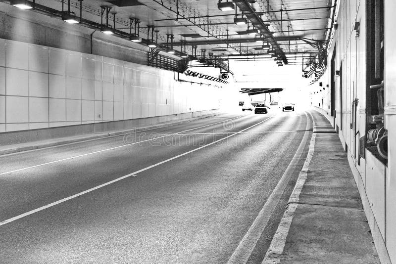 Long lightened tunnel for vehicles. Black and white photogrphy. Long lightened tunnel for vehicles. Black and white photogrphy.