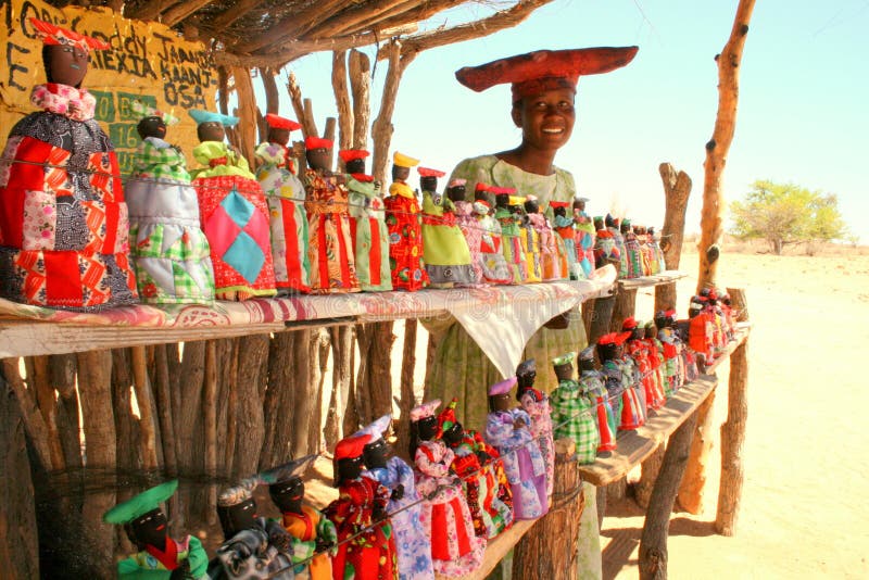 Indigenous Herero people in Namibia, Africa. the Herero sell handmade puppets and are known the wear colorful clothes and hats. Indigenous Herero people in Namibia, Africa. the Herero sell handmade puppets and are known the wear colorful clothes and hats