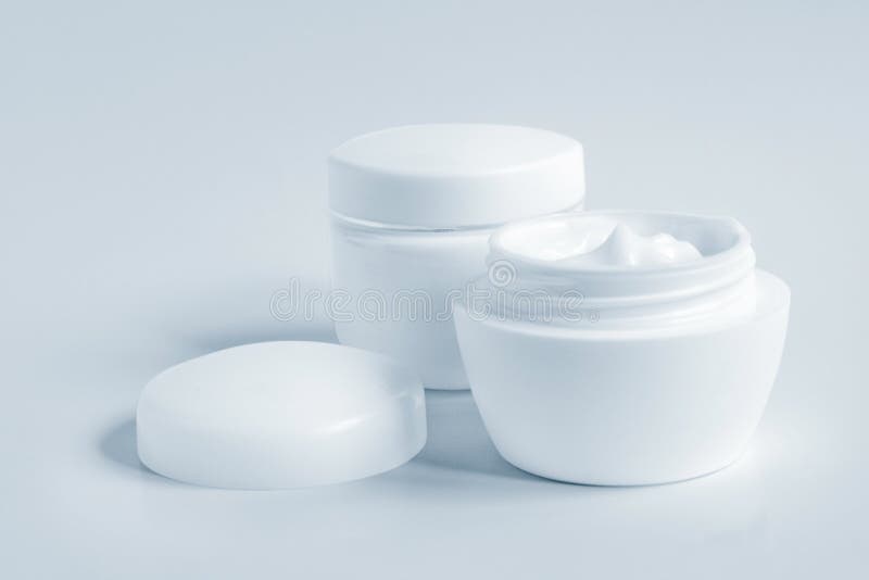 Containers of a different cosmetic creams. Close-up of a face cream. Containers of a different cosmetic creams. Close-up of a face cream.