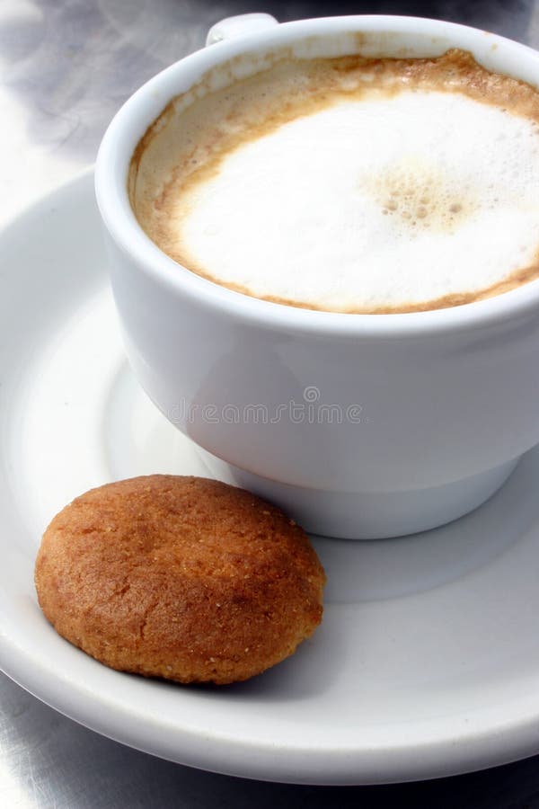 Coffee and single biscuit. Coffee and single biscuit