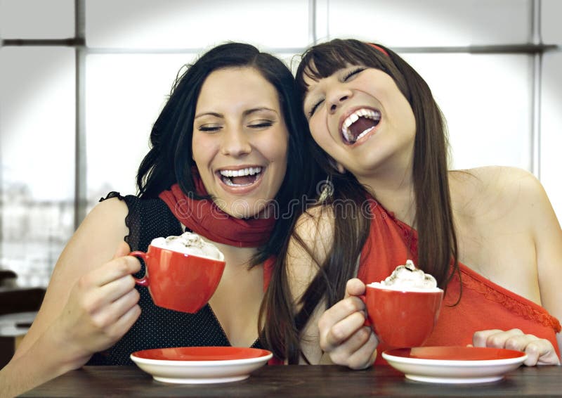 Two girls drinking coffee in a cafeteria. Two girls drinking coffee in a cafeteria