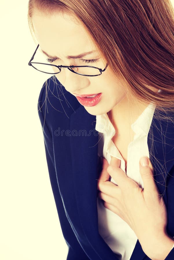 Beautiful business woman touching her chest, feeling unwell. Heart attack, health concept. Beautiful business woman touching her chest, feeling unwell. Heart attack, health concept.