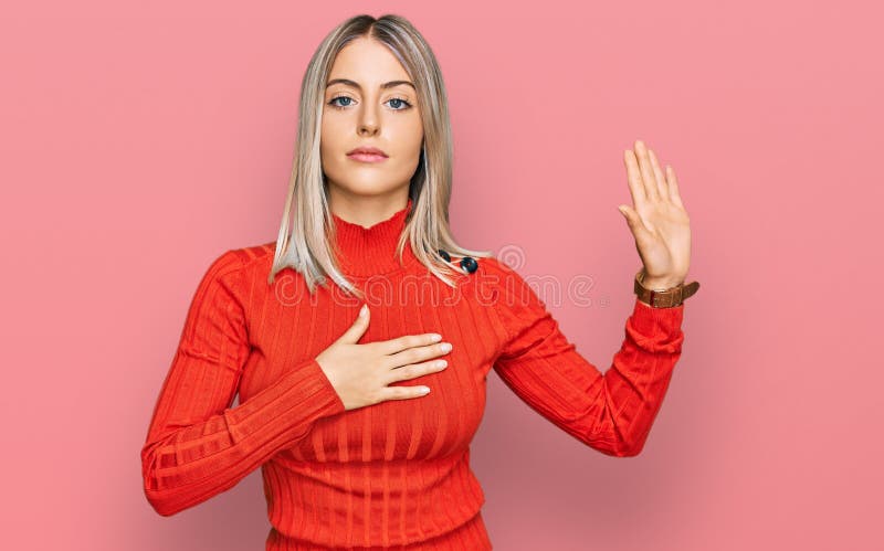 Beautiful blonde woman wearing casual clothes swearing with hand on chest and open palm, making a loyalty promise oath. Beautiful blonde woman wearing casual clothes swearing with hand on chest and open palm, making a loyalty promise oath