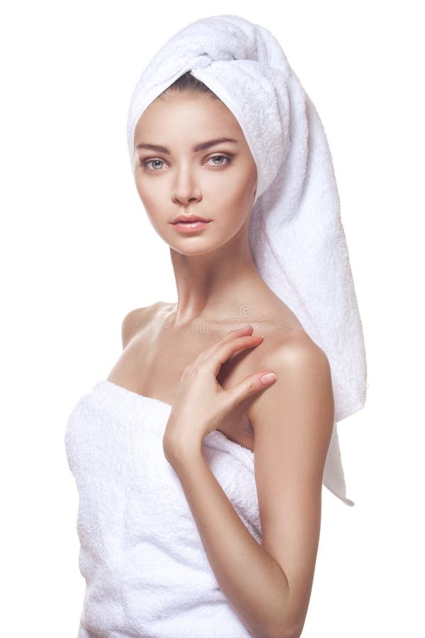 Beautiful young woman posing in white towel. Spa, healthcare. Isolated over white. Beautiful young woman posing in white towel. Spa, healthcare. Isolated over white.