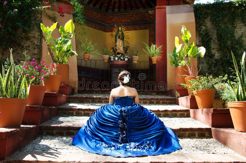 Lovely teen girl with a blue dress praying. Lovely teen girl with a blue dress praying