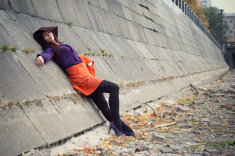 Stylish girl lying on a stone wall. Stylish girl lying on a stone wall