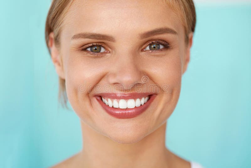 Beautiful Smile. Closeup Portrait Of Beautiful Happy Young Woman With Perfect White Teeth, Fresh Beauty Face And Healthy Soft Skin Smiling. Woman's Health, Skin Care Concept. High Resolution Image. Beautiful Smile. Closeup Portrait Of Beautiful Happy Young Woman With Perfect White Teeth, Fresh Beauty Face And Healthy Soft Skin Smiling. Woman's Health, Skin Care Concept. High Resolution Image