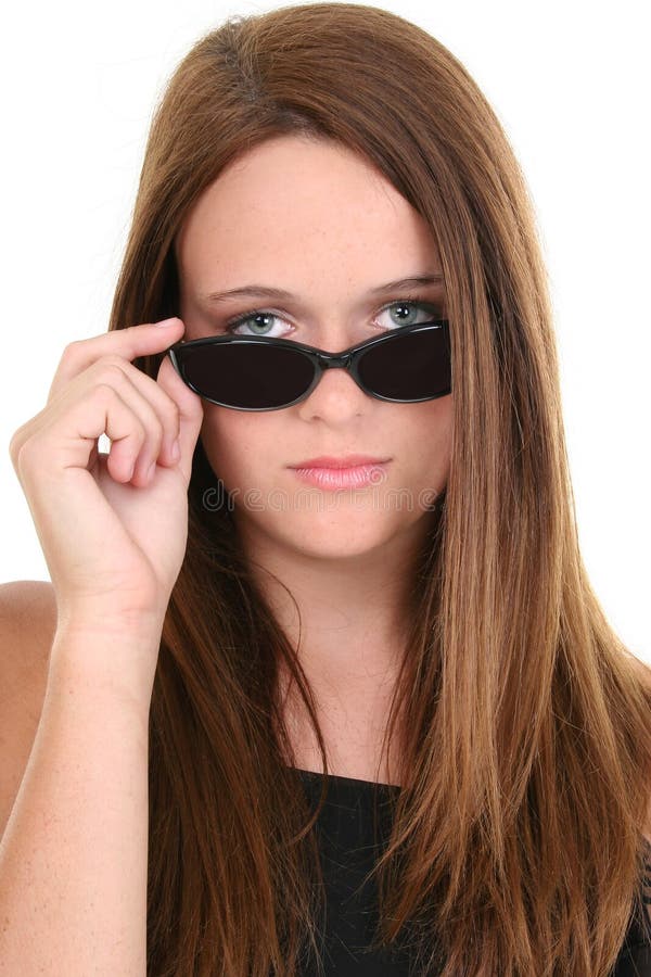 Portrait of a Beautiful Fourteen Year Old In Black Sunglasses. Shot in studio over white. Portrait of a Beautiful Fourteen Year Old In Black Sunglasses. Shot in studio over white.