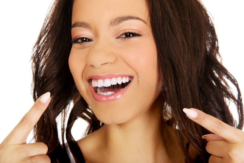 Beautiful african woman pointing to teeth. Beautiful african woman pointing to teeth.