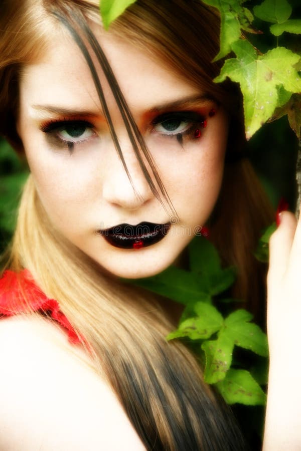 Beautiful 14 year old teen in goth make-up outside. Beautiful 14 year old teen in goth make-up outside.