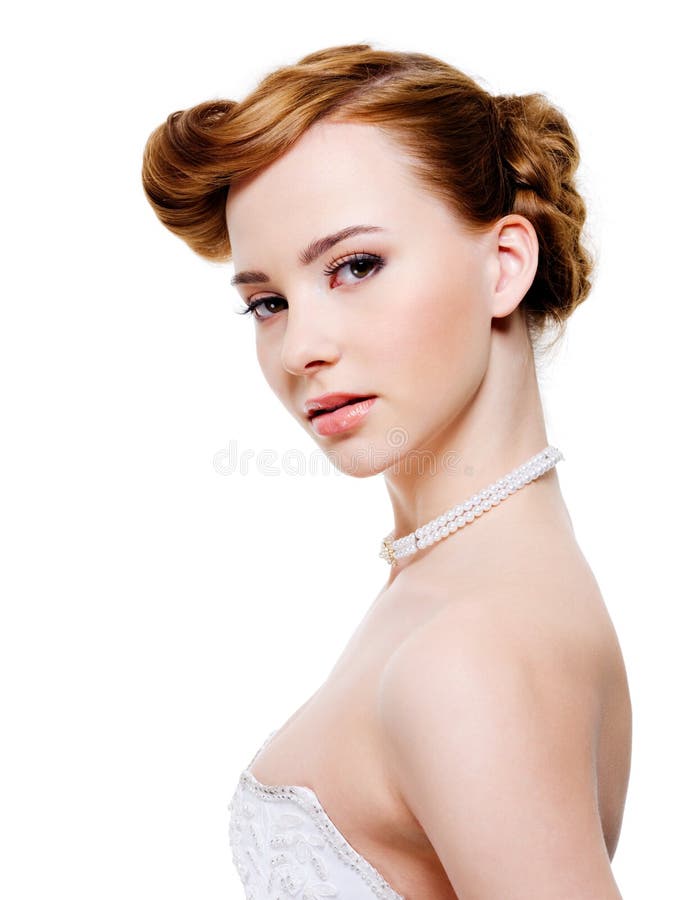 Young Beautiful bride with modern wedding hairstyle - on white background. Young Beautiful bride with modern wedding hairstyle - on white background