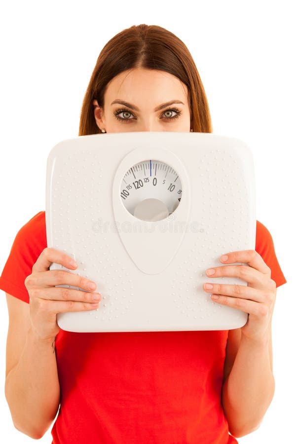 Красивые владения молодой женщины вычисляют по маcштабу как знак isolat weightloss стоковое изображение rf Красивые владения молодой женщины вычисляют по маcштабу как знак isolat weightloss стоковое изображение rf