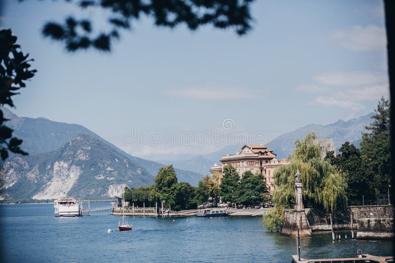 Красивый вид на старых зданиях и шлюпках на озере в городе Stresa, Италии Архитектура и берег на Lago Maggiore в солнечном дне да стоковое изображение