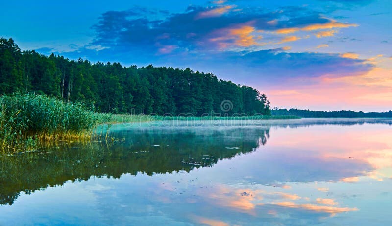 Beautiful panoramic view of the sunset over Lemiet lake in Mazury lake district, Poland. Lake landscape at sunset, fantastic travel destination. Masuria Polish: About this sound Mazury, German: Masuren is a region in northern Poland famous for its 2,000 lakes. It was once the part of East Prussia which was inhabited by Polish-speaking, Lutheran Masurians. Masuria occupies much of the Masurian Lake District Polish: Pojezierze Mazurskie . Administratively, it belongs to Warmian-Masurian Voivodeship Polish: wojewodztwo warminsko-mazurskie . Its biggest city is Elk, often regarded as its capital. It has territory of about 10,000 km2 and population of 500,000. Beautiful panoramic view of the sunset over Lemiet lake in Mazury lake district, Poland. Lake landscape at sunset, fantastic travel destination. Masuria Polish: About this sound Mazury, German: Masuren is a region in northern Poland famous for its 2,000 lakes. It was once the part of East Prussia which was inhabited by Polish-speaking, Lutheran Masurians. Masuria occupies much of the Masurian Lake District Polish: Pojezierze Mazurskie . Administratively, it belongs to Warmian-Masurian Voivodeship Polish: wojewodztwo warminsko-mazurskie . Its biggest city is Elk, often regarded as its capital. It has territory of about 10,000 km2 and population of 500,000.