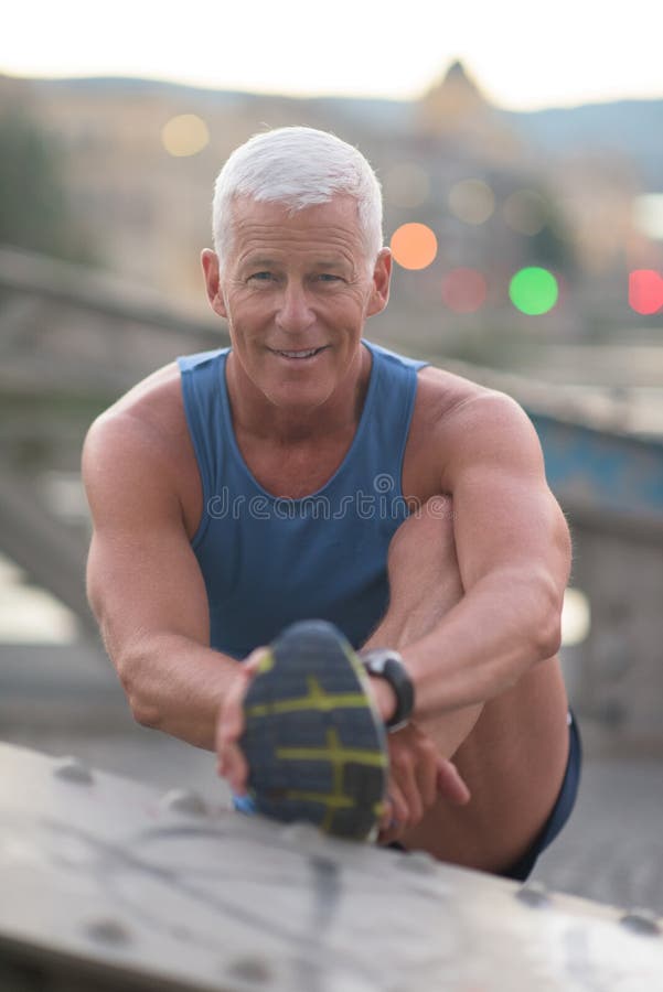 Красивый человек протягивая перед jogging стоковые изображения rf Красивый человек протягивая перед jogging стоковые изображения rf