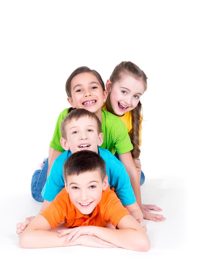 Five beautiful smiling kids lying on the floor in bright colorful t-shirts - isolated on white. Five beautiful smiling kids lying on the floor in bright colorful t-shirts - isolated on white.
