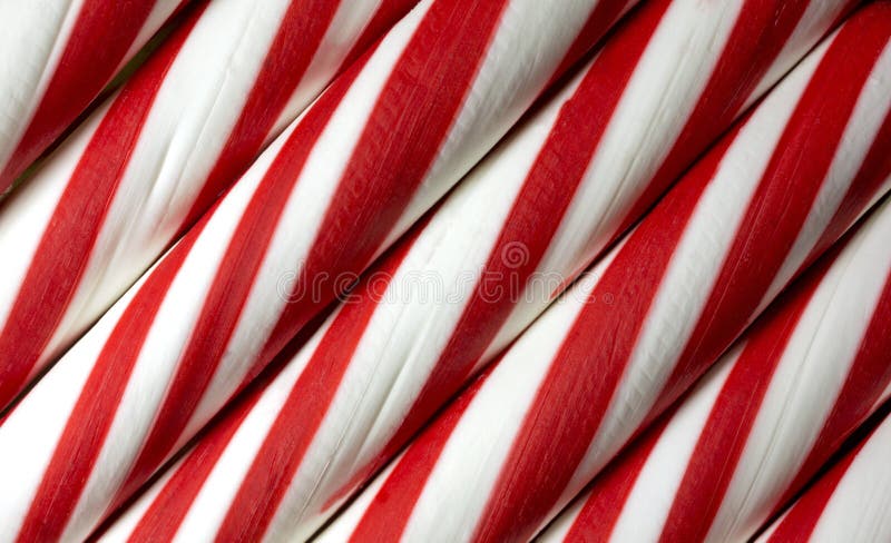 A close view of several sticks on red and white peppermint candy. A close view of several sticks on red and white peppermint candy.