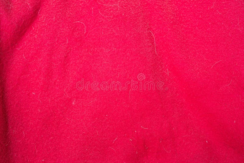 Красная текстура ткани с doghair и пятнами стоковая фотография Красная текстура ткани с doghair и пятнами стоковая фотография
