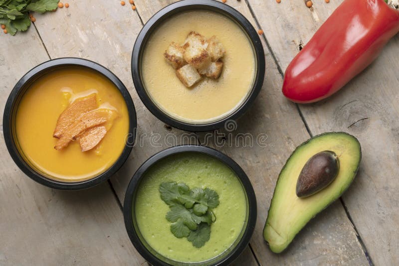 Красный пеец, половинное avacado и ложка около супов vegan в пищевых контейнерах, готовая еда, который нужно съесть стоковые изображения rf Красный пеец, половинное avacado и ложка около супов vegan в пищевых контейнерах, готовая еда, который нужно съесть стоковые изображения rf