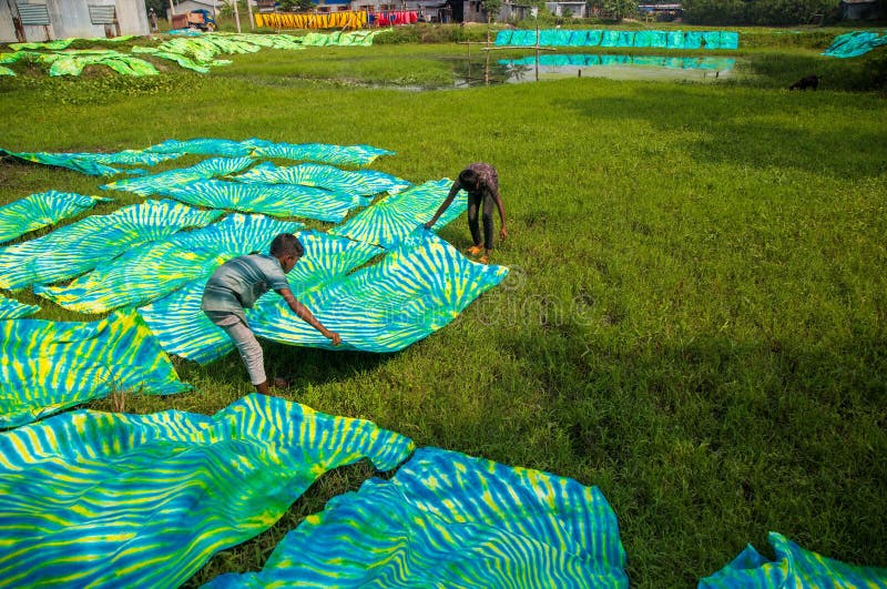 Waves of every color swaying in the wind , and a sweet scent of freshly cut fabric everywhere. It seems the waves of color extended towards horizon. This scene is from Narayanganj's Araihajar Banti, Rupganj's Noagaon and Chanpara villages.A village which once was surrounded by scarcity, its children could not go to school as their parents were unable to pay the fees, now changed the scenario up side down and become a role model for the whole country. Now the families of these villages associated with batik business are earning Tk 2,160 crores annually.Banti village is only 32 km away from Dhaka. All those three villages including Banti are now famous for batik. Batik cloths of three villages are sold in Banti Bazar. Abdul Hai Bhuiyan, President of Banti Bazaar Traders Association, said that batik business started in this market in 1981. At present it has turned into a hub. There are 22 small and big markets on both sides of this hub. There are almost 2500 shops in these markets. Right now 1,500 shops are in operation. The rest of the shops will also open before the next holy month of Ramadan and Pahela Baisakh. Each of the 1,500 shops sell an average of Tk 40,000 worth of batik goods per day. According to that, there is a business of 180 crore rupees per month. And the annual business is 2 thousand 160 crore Taka.From dawn to dusk, the men and women of these villages are busy making batik. As far as the eye can see, cloths painted in various traditional designs are seen hanging on ropes. Residents of the village are dyeing clothes in the yard, side roads, land or open fields, some are blocking, others are drying wet clothes in the sun. Waves of every color swaying in the wind , and a sweet scent of freshly cut fabric everywhere. It seems the waves of color extended towards horizon. This scene is from Narayanganj's Araihajar Banti, Rupganj's Noagaon and Chanpara villages.A village which once was surrounded by scarcity, its children could not go to school as their parents were unable to pay the fees, now changed the scenario up side down and become a role model for the whole country. Now the families of these villages associated with batik business are earning Tk 2,160 crores annually.Banti village is only 32 km away from Dhaka. All those three villages including Banti are now famous for batik. Batik cloths of three villages are sold in Banti Bazar. Abdul Hai Bhuiyan, President of Banti Bazaar Traders Association, said that batik business started in this market in 1981. At present it has turned into a hub. There are 22 small and big markets on both sides of this hub. There are almost 2500 shops in these markets. Right now 1,500 shops are in operation. The rest of the shops will also open before the next holy month of Ramadan and Pahela Baisakh. Each of the 1,500 shops sell an average of Tk 40,000 worth of batik goods per day. According to that, there is a business of 180 crore rupees per month. And the annual business is 2 thousand 160 crore Taka.From dawn to dusk, the men and women of these villages are busy making batik. As far as the eye can see, cloths painted in various traditional designs are seen hanging on ropes. Residents of the village are dyeing clothes in the yard, side roads, land or open fields, some are blocking, others are drying wet clothes in the sun.