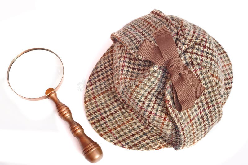 Крышка Deerstalker или Sherlock Holmes и лупа года сбора винограда стоковое фото rf Крышка Deerstalker или Sherlock Holmes и лупа года сбора винограда стоковое фото rf