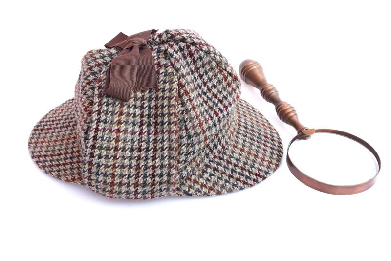 Крышка Deerstalker или Sherlock Holmes и лупа года сбора винограда стоковое фото rf Крышка Deerstalker или Sherlock Holmes и лупа года сбора винограда стоковое фото rf