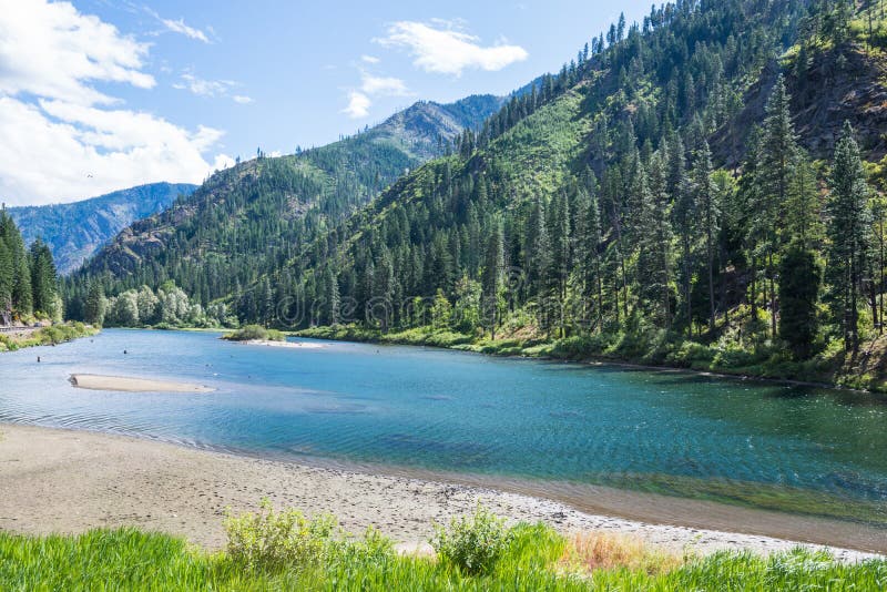 Landscape of turquoise river in evergreen forested mountains, Washington State. Landscape of turquoise river in evergreen forested mountains, Washington State.