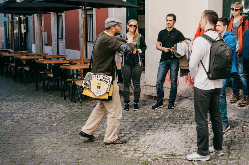 Lisbon, June 18, 2018: A guide from local residents tells tourists on a free tour of the sights of the city. Free tour from local. Lisbon, June 18, 2018: A guide from local residents tells tourists on a free tour of the sights of the city. Free tour from local.