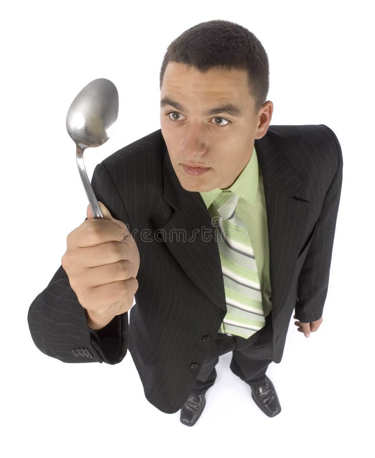 Isolated on white businessman bending spoon by mind force. Isolated on white businessman bending spoon by mind force