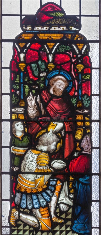 LONDON, GREAT BRITAIN - SEPTEMBER 19, 2017: Peter Baptizing the Centurion Cornelius on the stained glass in St Mary Abbot`s church on Kensington High Street. LONDON, GREAT BRITAIN - SEPTEMBER 19, 2017: Peter Baptizing the Centurion Cornelius on the stained glass in St Mary Abbot`s church on Kensington High Street.