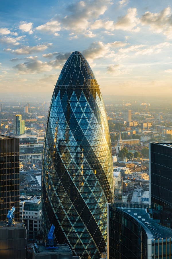 LONDON - OCTOBER 1: Gherkin building &#x28;30 St Mary Axe&#x29; during sunrise in London on October 1, 2015. 30 St Mary Axe building is one of architectural symbols of London, thanks to it&#x27;s shape nicknamed Gherkin. LONDON - OCTOBER 1: Gherkin building &#x28;30 St Mary Axe&#x29; during sunrise in London on October 1, 2015. 30 St Mary Axe building is one of architectural symbols of London, thanks to it&#x27;s shape nicknamed Gherkin